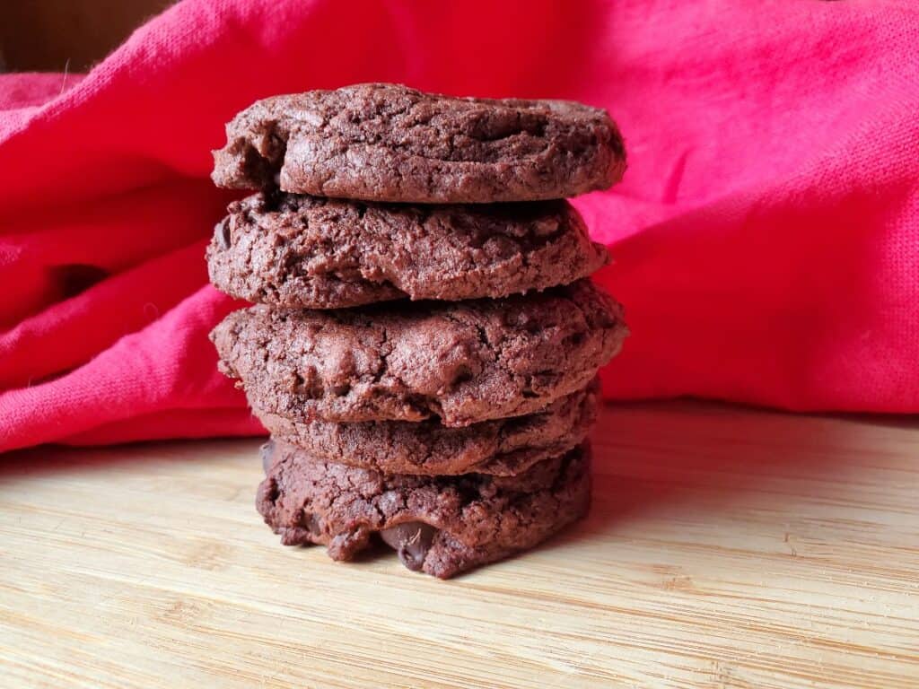 Stack of 5 candy candy brookies with a red cloth in the background.