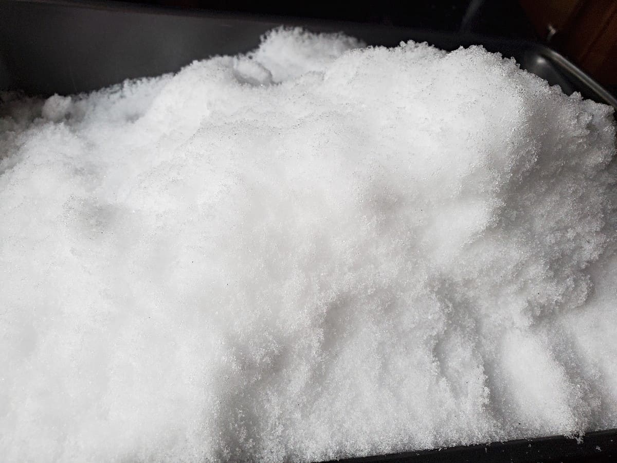 Pile of fresh snow with a black background.