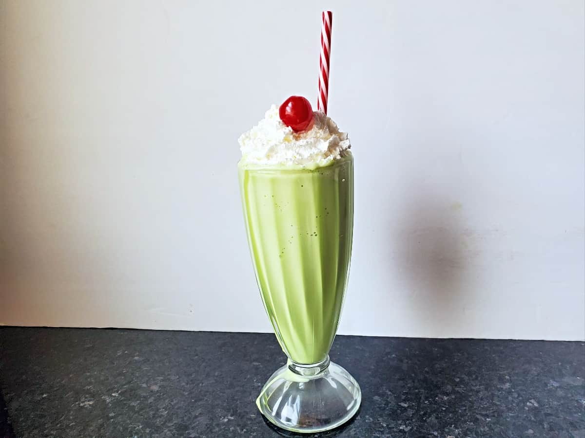 Copycat shamrock shake with whipped cream and cherry.