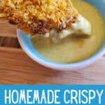 Chicken dipped in honey mustard with text homemade crispy chicken fingers.