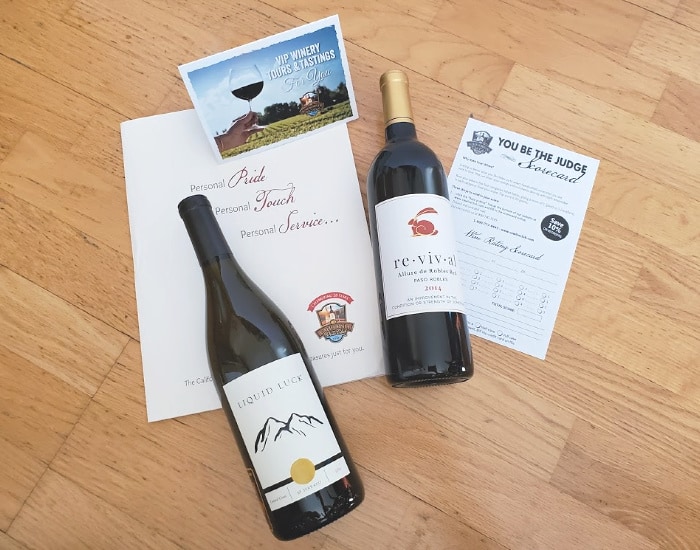 Overhead image of two wine bottles with wine club information.