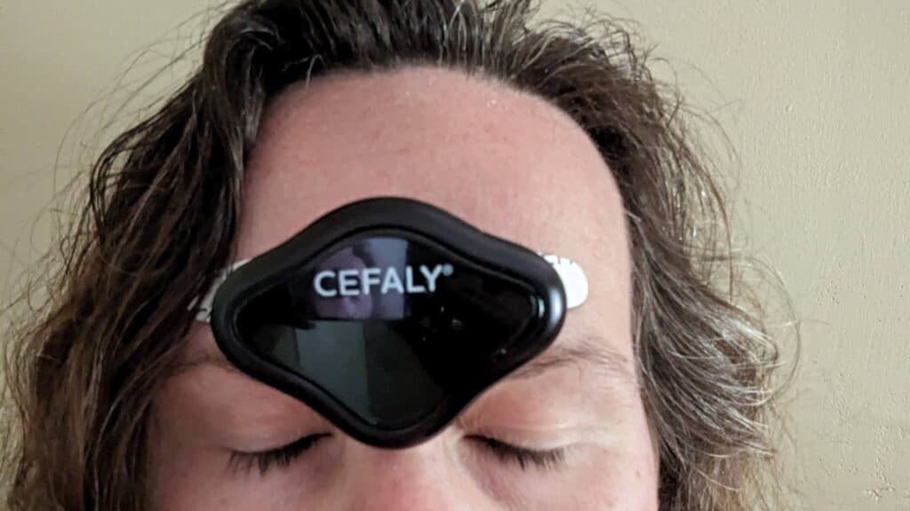 Image shows a Woman with CEFALY device on her forehead.