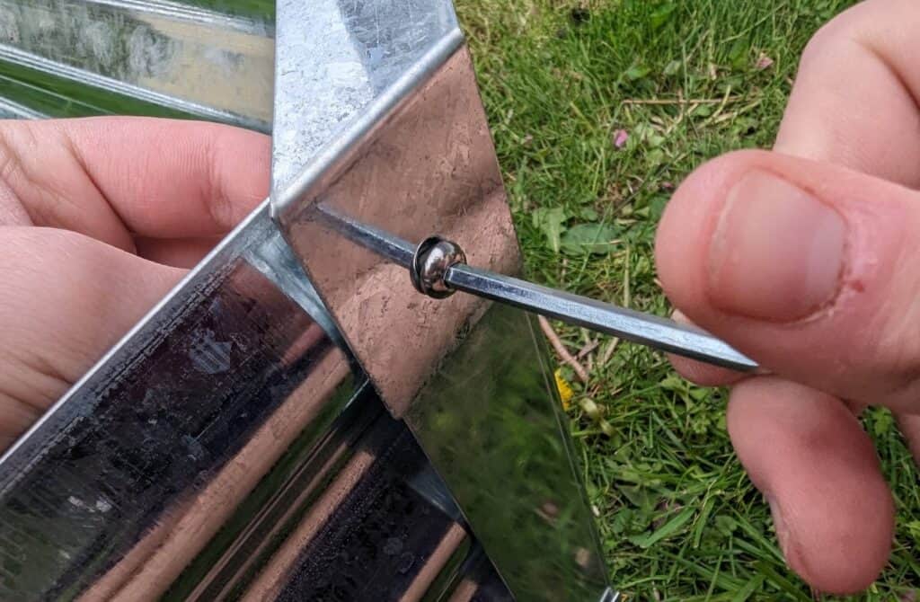 Screwing together a raised garden bed.