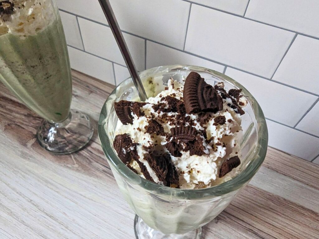 Image shows aNear overhead of copycat shamrock mcflurry with a spoon.