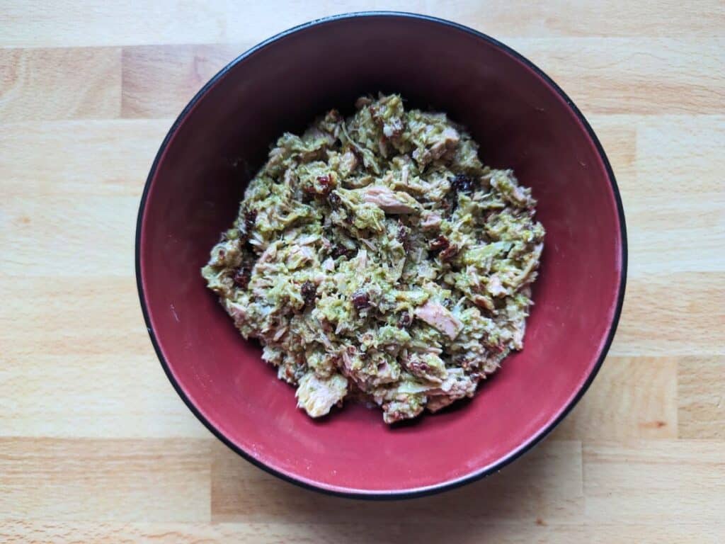 Image shows a Bowl of pesto tomato salad from overhead.