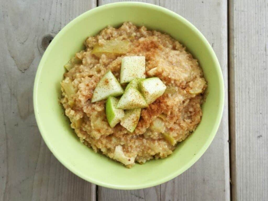 Image shows caramelized apple oatmeal in a bowl.