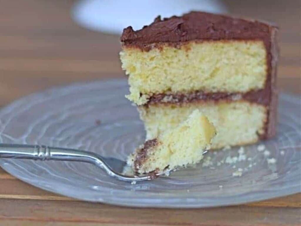 Image shows classic yellow cake served on a plate.