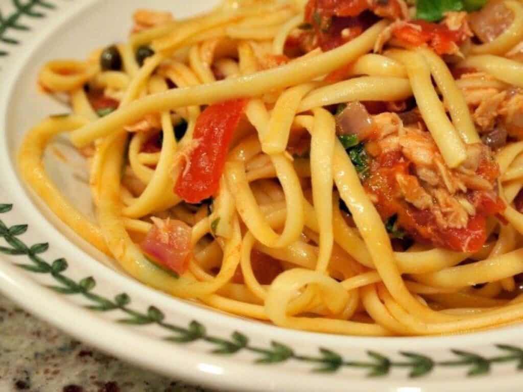 Image shows close up of tuna and tomato pasta on a plate.