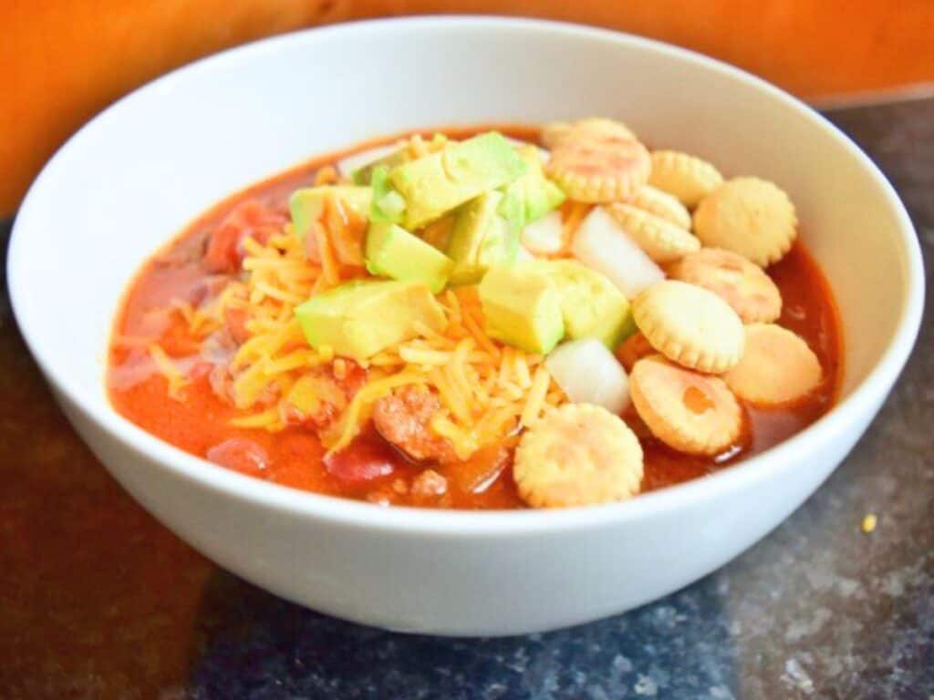 Image shows crockpot chili in a bowl.