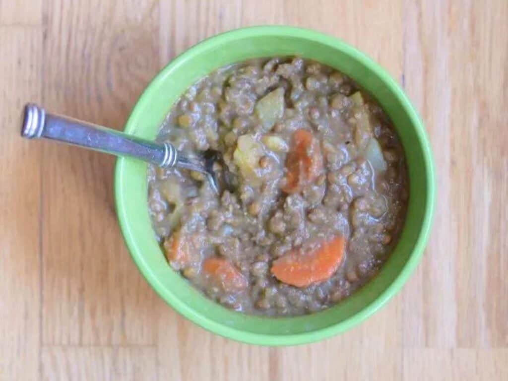 Image shows instant pot lentil soup in a bowl.