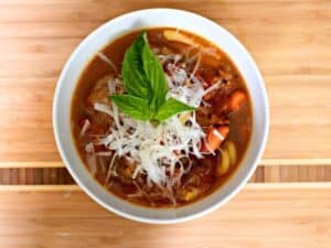 Image shows Italian meatball soup in a bowl.