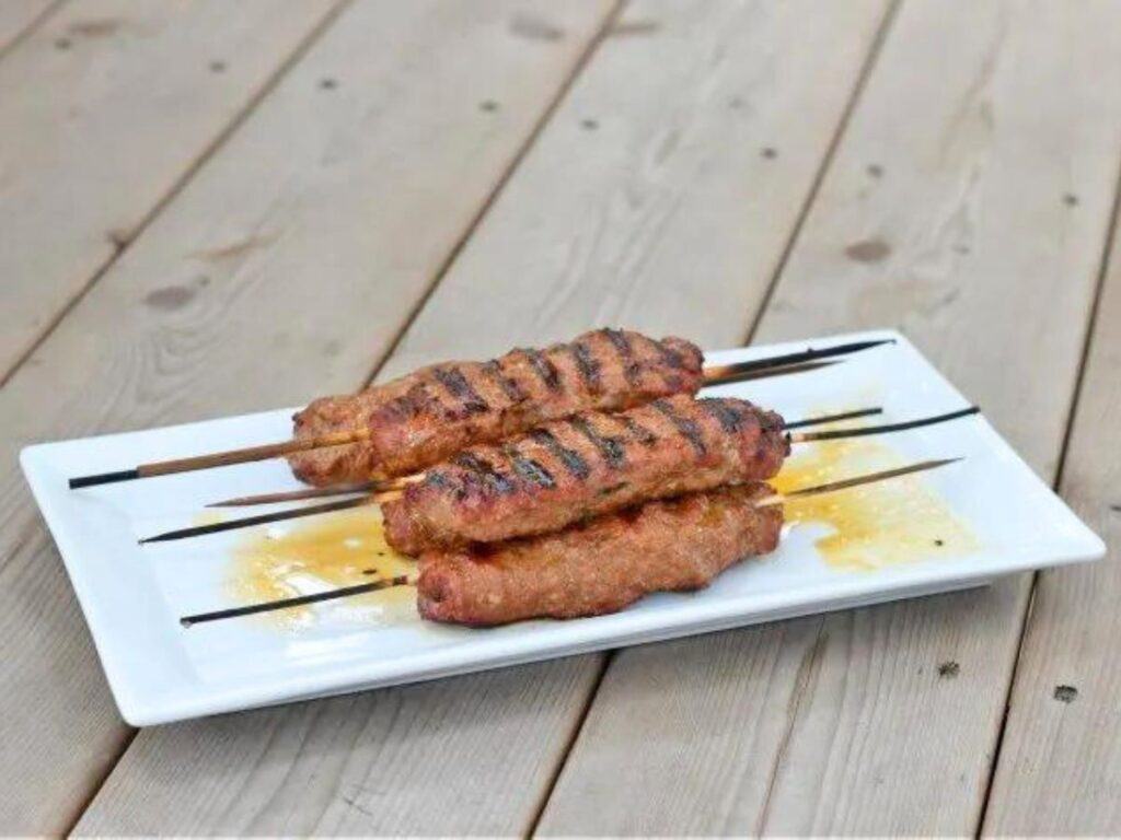 Image shows Kefta kebabs on a plate for dinner.