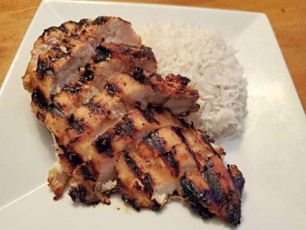 Image shows miso glazed chicken served with rice.