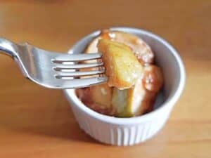 Image shows small portion of cinnamon apples on a fork.