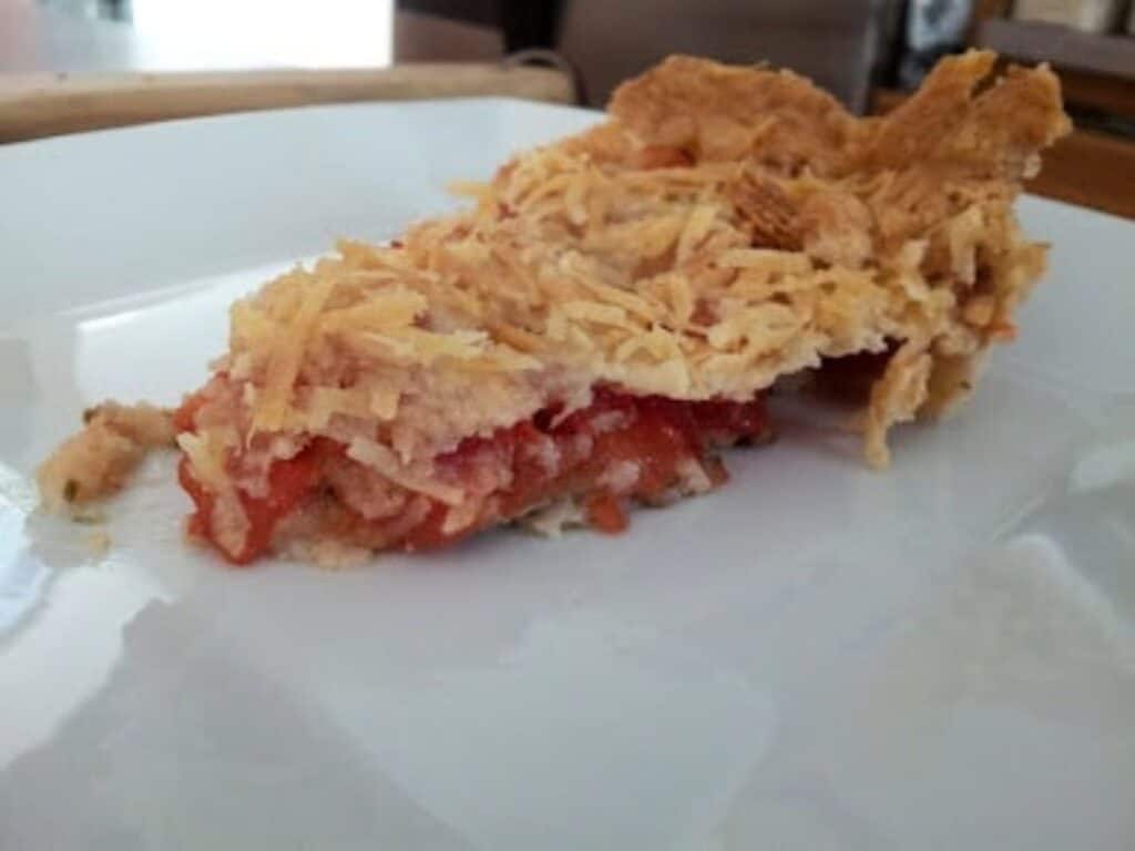 Image shows tomato tart served on a plate.
