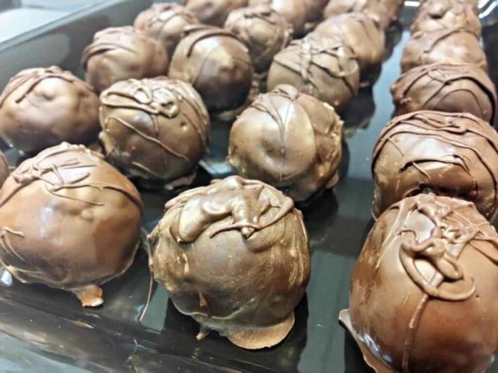 Image shows yummy cookie dough chocolate chip truffles in a tray.