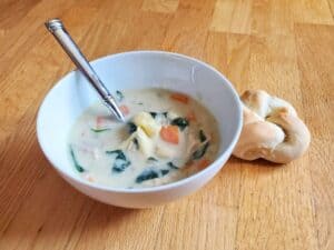 Image shows irresistible creamy chicken tortellini soup.