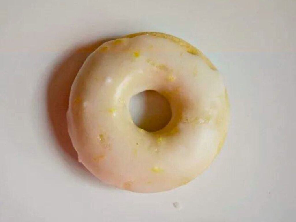 Image shows irresistible homemade lemon glazed donuts.