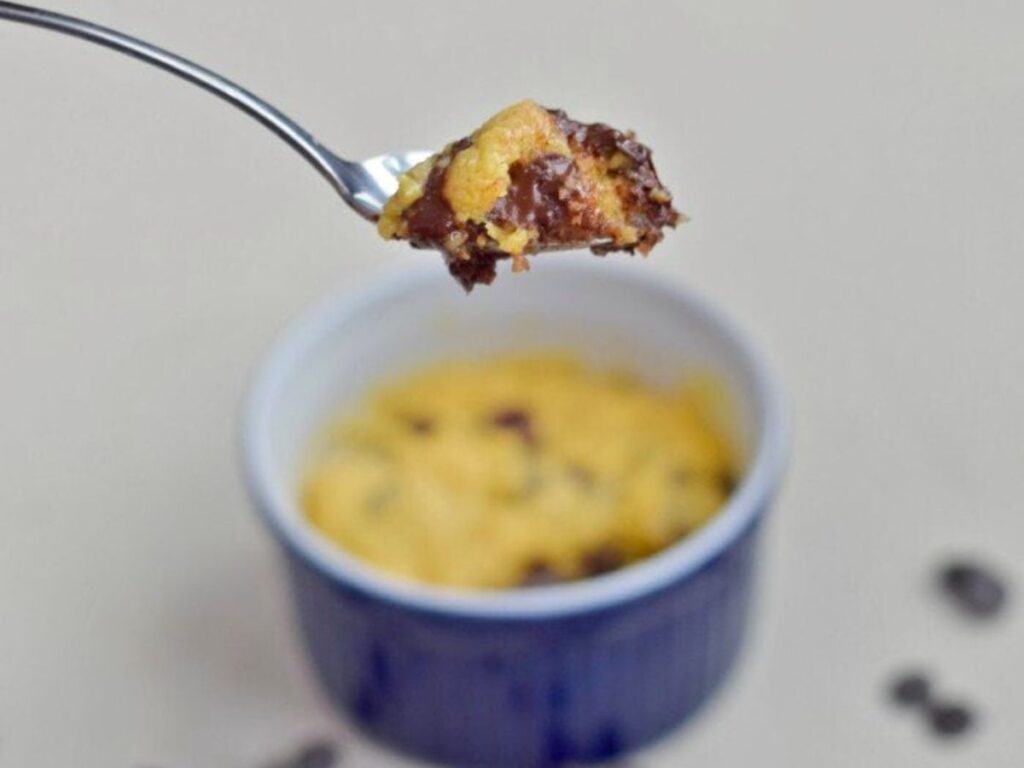 Image shows bite of delicious microwave chocolate chip cookie.