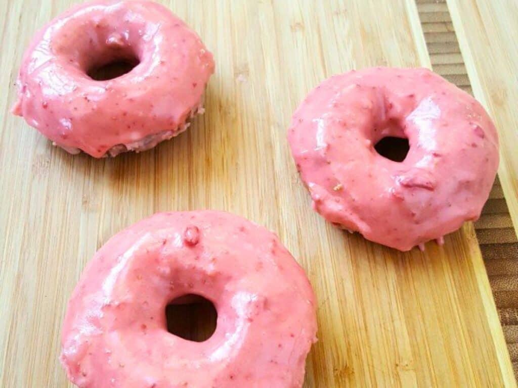 Image shows delicious homemade strawberry donut.