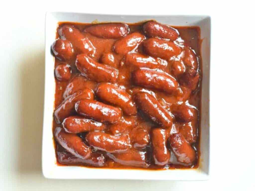 Image shows bowl of irresistible bbq bourbon little smokies.