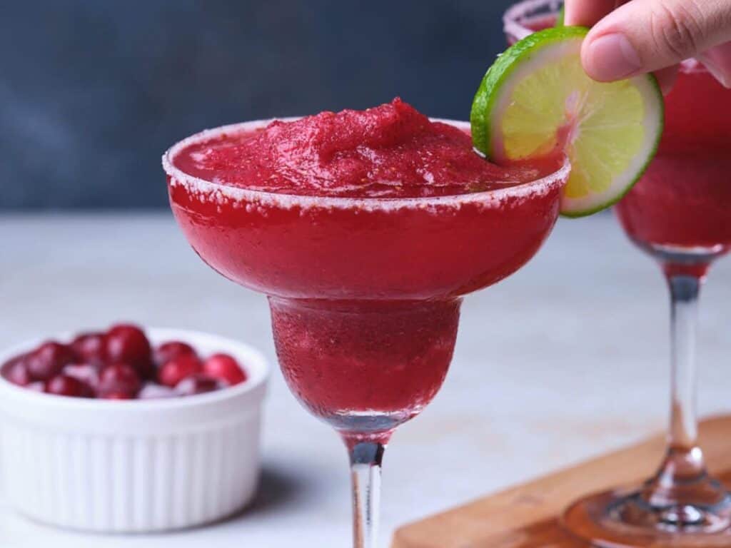 Image shows delicious frozen cranberry margarita.