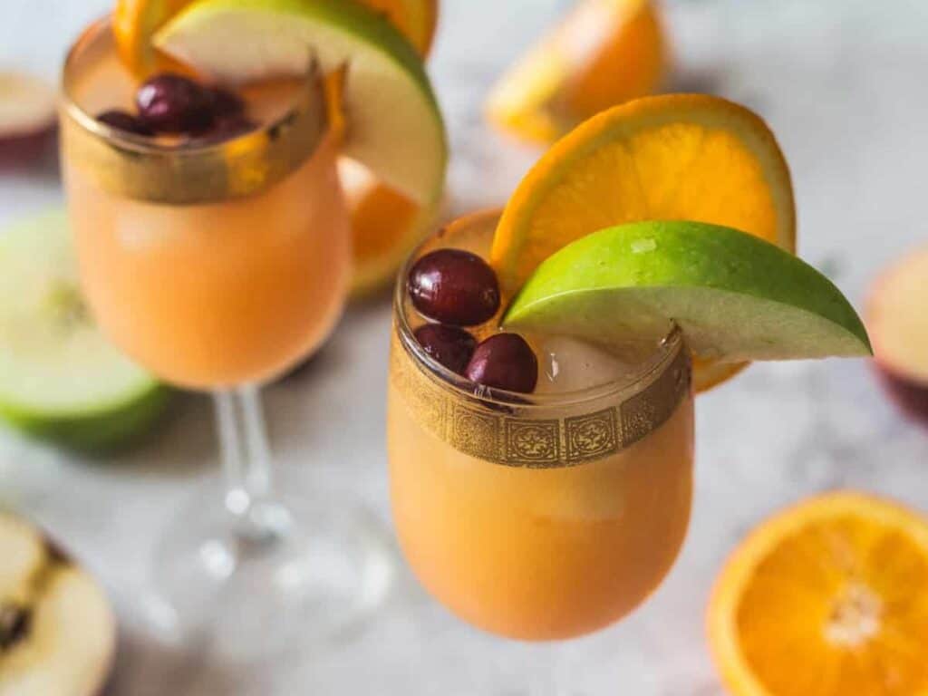 Image shows delicious orange cranberry sangria mocktail.