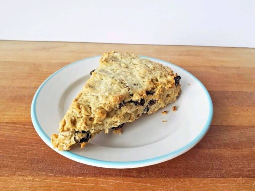 Image shows easy to make buttermilk raisin scone on a plate.