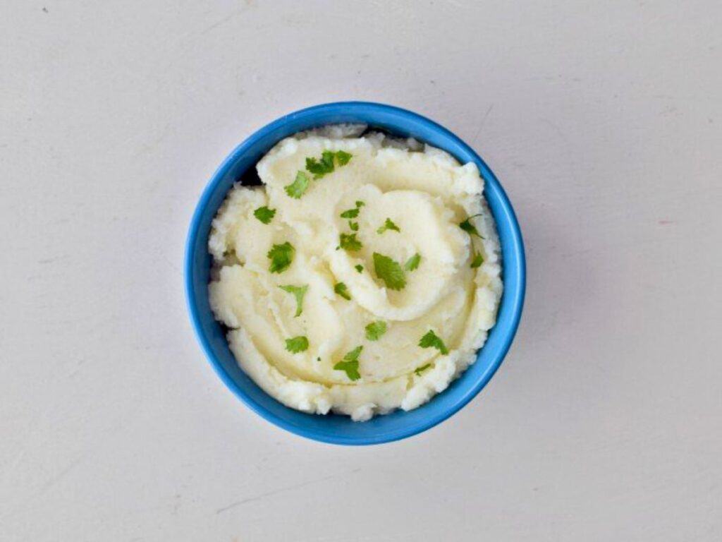 Image shows yummy mashed potatoes in a bowl.