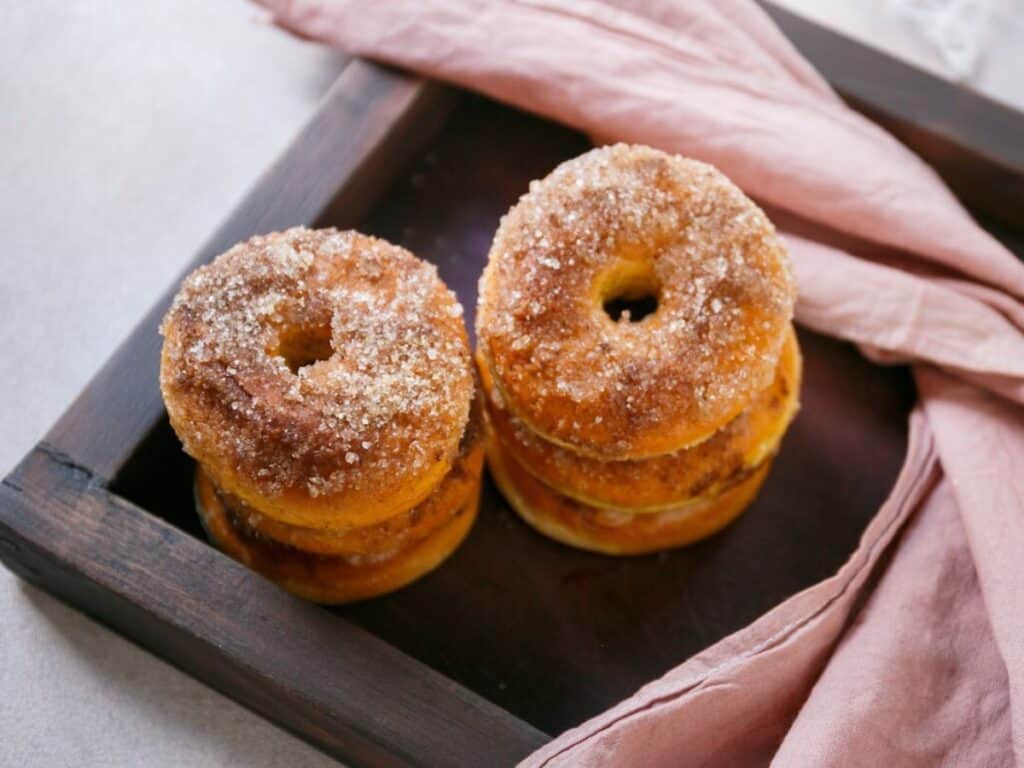 Image shows delicious baked pumpkin donut.