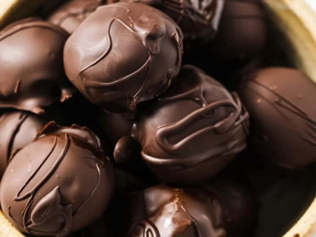 Image shows close-up of delicious chocolate peanut butter balls.