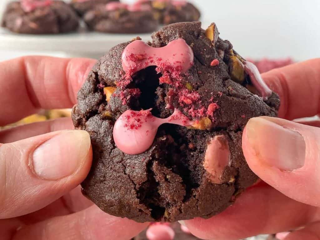 Image shows hnads holiding irresistible Ruby Chocolate Chip Cookies.