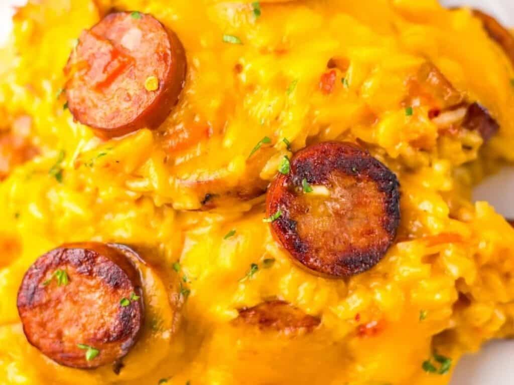 Image shows delicious one pot cheesy sausage and rice casserole.