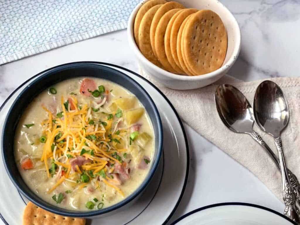 Image shows delicious slow cooker ham and potato chowder.