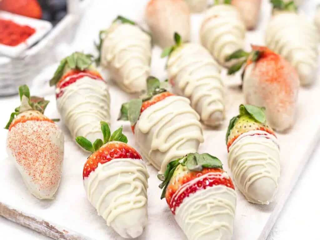Image shows delicious white chocolate covered strawberries.