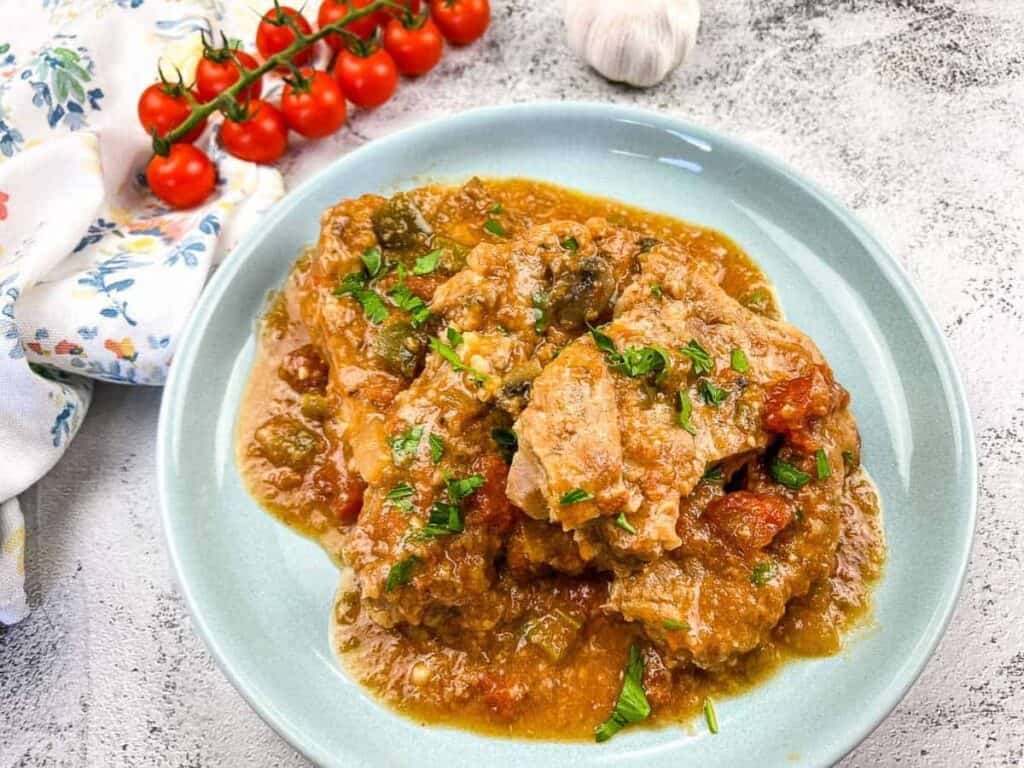 Image shows easy to make slow cooker Swiss pork chops.