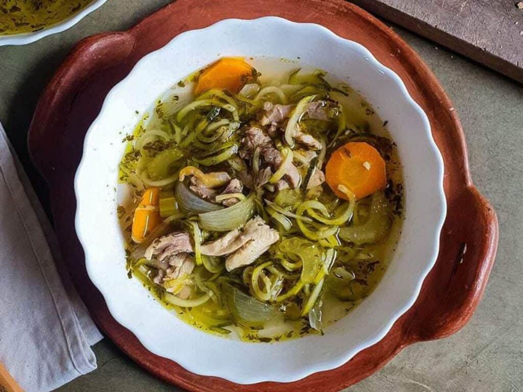 Image shows easy to make slow cooker chicken zoodle soup.