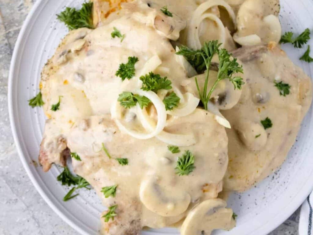 Image shows irresistible crock pot smothered pork chops.