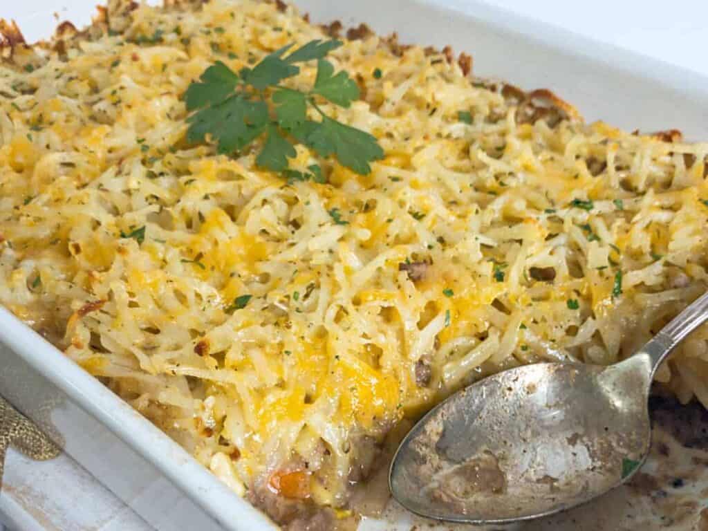 Image shows irresistible hamburger hashbrown casserole.