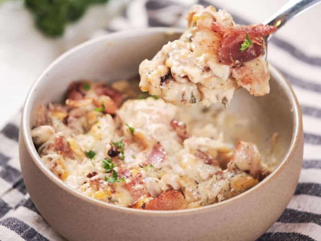 Image shows irresistible slow cooker cheesy ranch chicken.