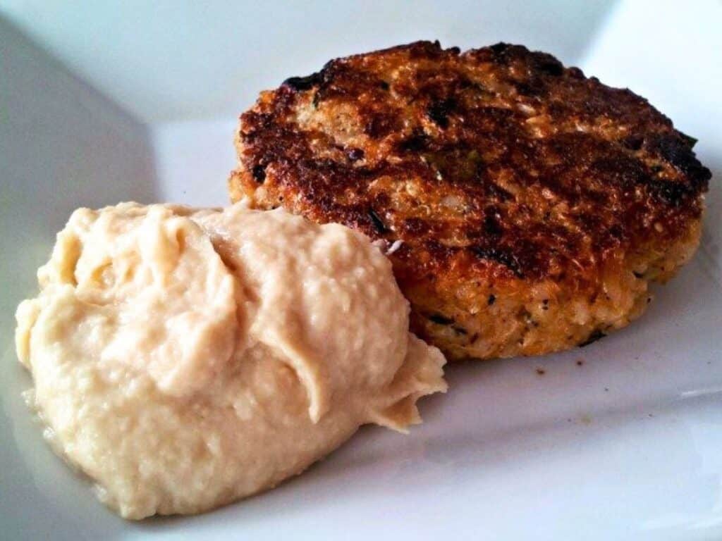 Image shows vegan quinoa burger with delicious roasted parsnip puree.