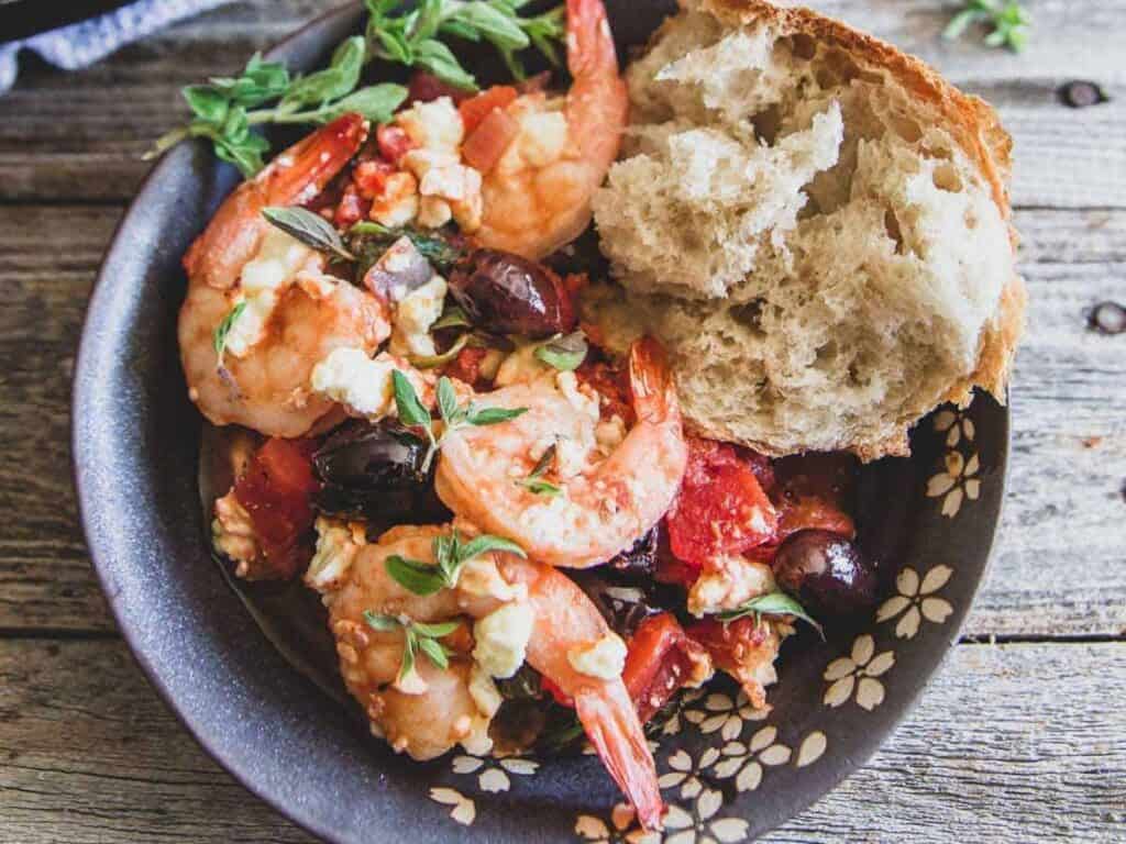 Image shows yummy Greek shrimp skillet.