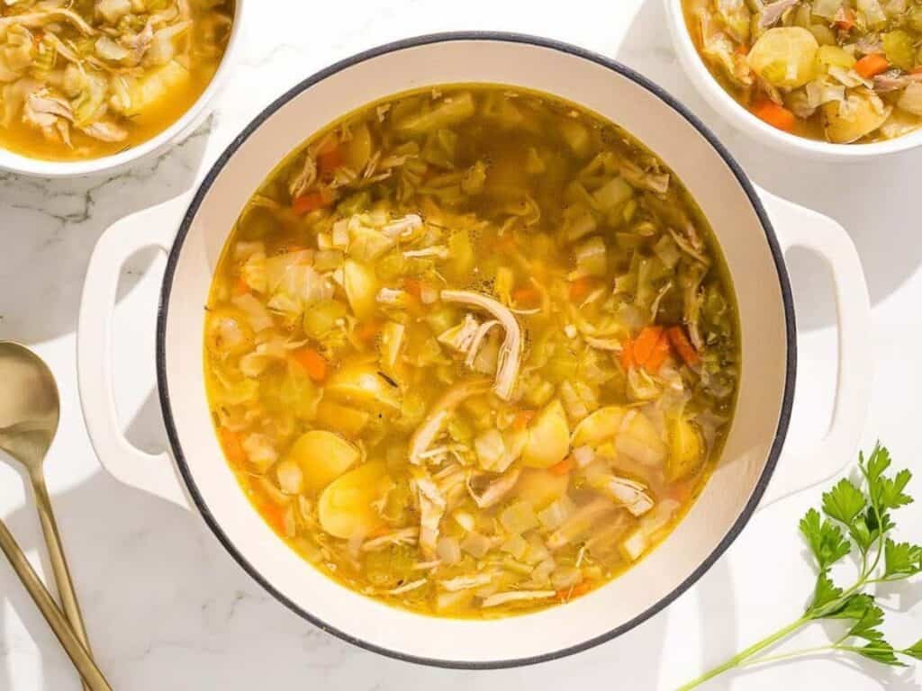 Image shows yummy chicken and cabbage soup with ginger.
