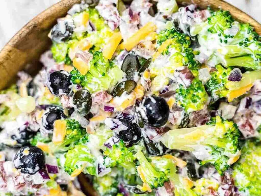 Image shows delicious broccoli salad with bacon.
