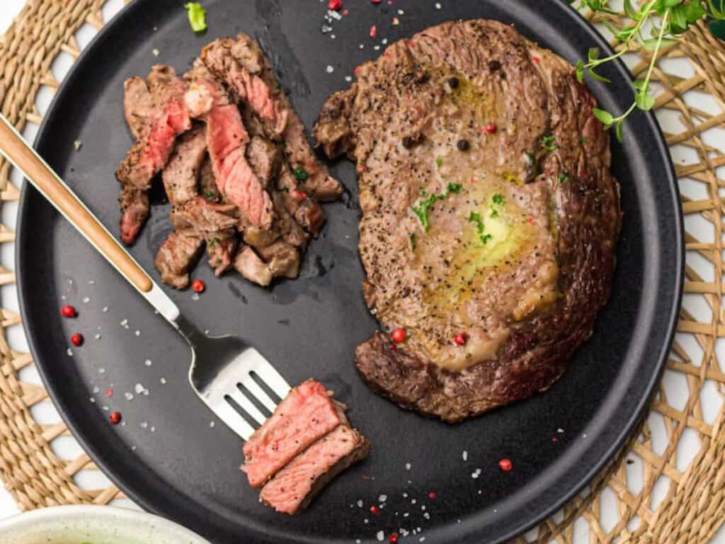 Image shows irresistible air fryer ribeye steaks.