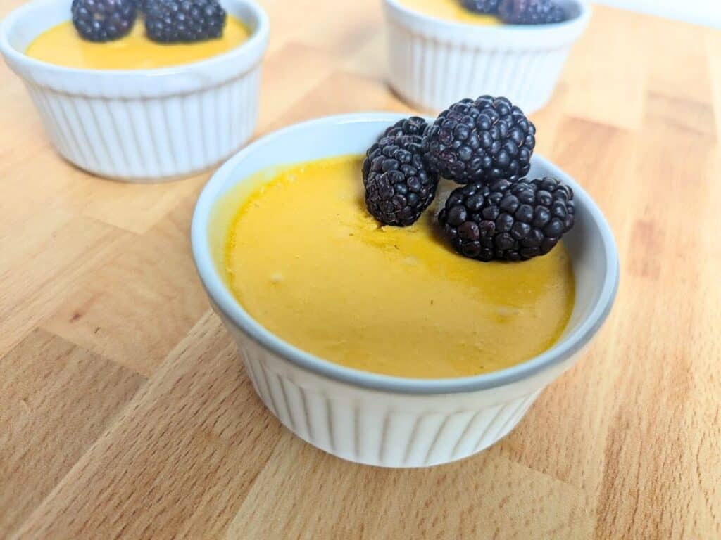 Image shows mango mousse in a ramekin.