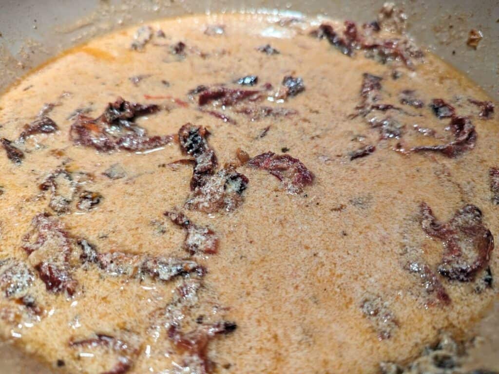 Image shows simmering the sauce for the salmon.