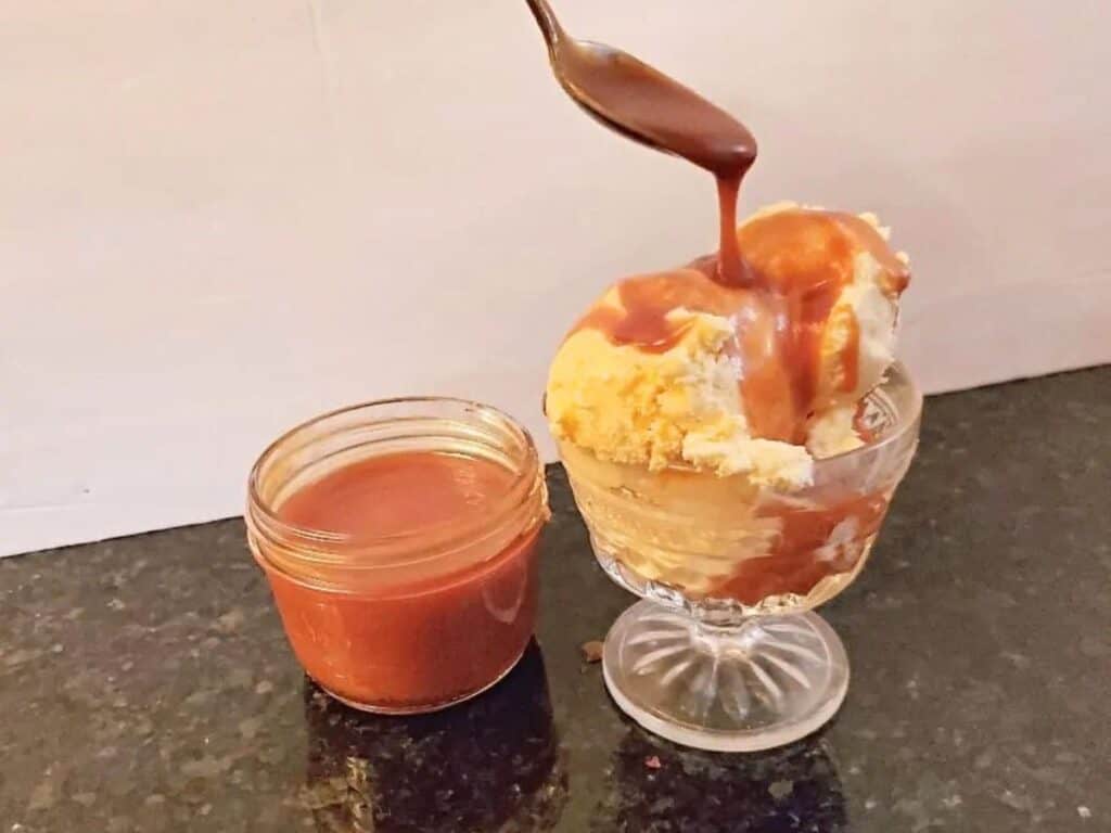 Image shows adding delicious salted caramel sauce to ice cream.
