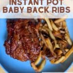 Image shows overhead view of cooked baby back ribs on a blue plate.