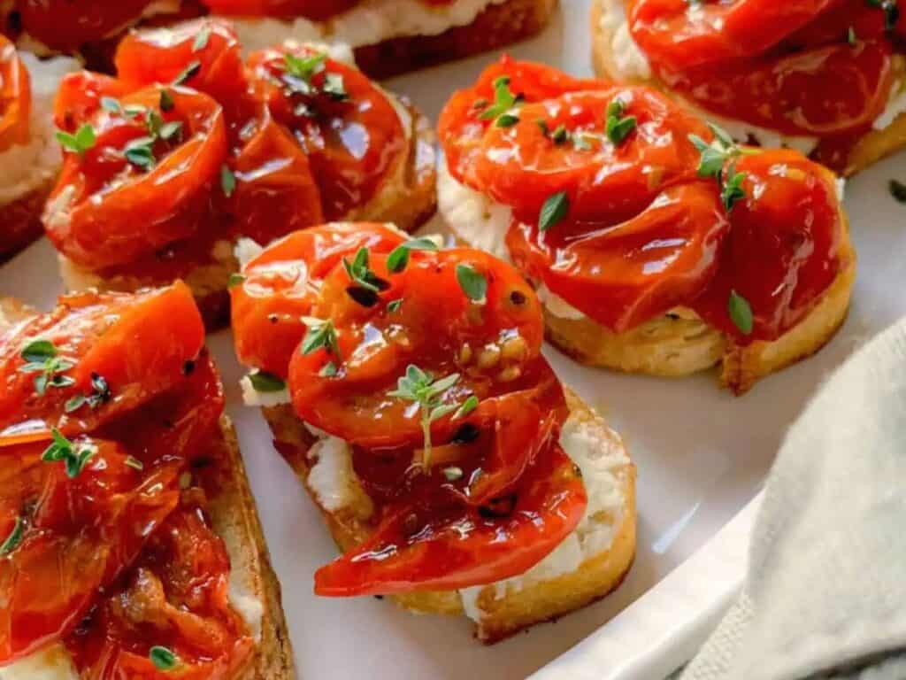 Image shows classic roasted tomato crostini with whipped feta recipe.
